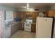 Functional kitchen featuring wooden cabinets, appliances, and a window at 17862 N 31St Ave, Phoenix, AZ 85053