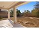 Covered patio overlooks a large backyard at 19234 W Woodlands Ave, Buckeye, AZ 85326