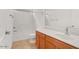 Clean bathroom with tub, toilet and wood vanity at 19234 W Woodlands Ave, Buckeye, AZ 85326