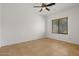 Simple bedroom with tile floors and ceiling fan at 19234 W Woodlands Ave, Buckeye, AZ 85326