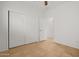 Bedroom with mirrored closet doors and tile floors at 19234 W Woodlands Ave, Buckeye, AZ 85326