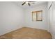 Simple bedroom with tile floors and window at 19234 W Woodlands Ave, Buckeye, AZ 85326