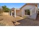 Home's exterior with a covered patio and yard at 19234 W Woodlands Ave, Buckeye, AZ 85326