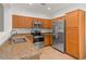 Modern kitchen with stainless steel appliances and granite counters at 19234 W Woodlands Ave, Buckeye, AZ 85326