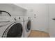 Bright laundry room with washer and dryer included at 19234 W Woodlands Ave, Buckeye, AZ 85326