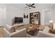 Living room with neutral decor and built-in shelving at 19234 W Woodlands Ave, Buckeye, AZ 85326