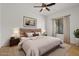 Main bedroom with king bed and window coverings at 19234 W Woodlands Ave, Buckeye, AZ 85326