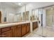 Bathroom features double sinks, wood cabinets, and a large mirror at 19550 N Grayhawk Dr # 1136, Scottsdale, AZ 85255