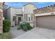 Inviting stucco and stone exterior, two-car garage, and landscaped front yard at 19550 N Grayhawk Dr # 1136, Scottsdale, AZ 85255