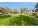 Expansive green lawn with mature trees and a building in the background at 19550 N Grayhawk Dr # 1136, Scottsdale, AZ 85255