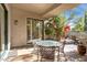 Private patio with seating area and glass-top table at 19550 N Grayhawk Dr # 1136, Scottsdale, AZ 85255