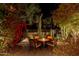 Night view of a cozy patio with fire pit and seating area at 19550 N Grayhawk Dr # 1136, Scottsdale, AZ 85255