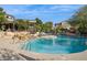 Community pool with plenty of lounge chairs and a waterfall feature at 19550 N Grayhawk Dr # 1136, Scottsdale, AZ 85255