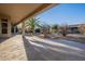 Spacious backyard patio with desert landscaping and seating area at 19608 N Regents Park Dr, Surprise, AZ 85387