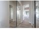 Long hallway with mirrored closet doors leading to a bathroom at 19608 N Regents Park Dr, Surprise, AZ 85387