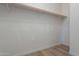 Large closet with wood shelving and ample hanging space at 19608 N Regents Park Dr, Surprise, AZ 85387