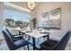 Modern dining room with marble table, black chairs, and large window at 19608 N Regents Park Dr, Surprise, AZ 85387