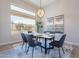 Elegant dining room with marble table, modern chairs, and large window at 19608 N Regents Park Dr, Surprise, AZ 85387