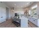 Modern kitchen with white cabinets and a large island at 19608 N Regents Park Dr, Surprise, AZ 85387