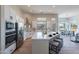 Modern kitchen with island, stainless steel appliances, and white cabinets at 19608 N Regents Park Dr, Surprise, AZ 85387