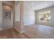 Spacious living room with hardwood floors and large window views at 19608 N Regents Park Dr, Surprise, AZ 85387