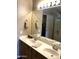 Double vanity bathroom with a large mirror and updated fixtures at 2030 N 108Th N Dr, Avondale, AZ 85392