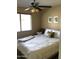 Bright bedroom with a queen-size bed and ceiling fan at 2030 N 108Th N Dr, Avondale, AZ 85392