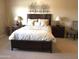 Main bedroom with dark wood furniture and wall art at 2030 N 108Th N Dr, Avondale, AZ 85392