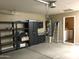 Garage with storage shelving and water heater at 2030 N 108Th N Dr, Avondale, AZ 85392