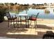 Relaxing patio with table and chairs overlooking a lake at 2030 N 108Th N Dr, Avondale, AZ 85392