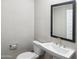 Clean bathroom with pedestal sink, toilet and mirror at 21047 N 58Th Way, Phoenix, AZ 85054