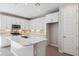 Modern kitchen with white cabinets, island, and stainless steel appliances at 21047 N 58Th Way, Phoenix, AZ 85054