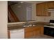 Kitchen with double sink, dishwasher, and wood cabinets at 2138 W Beaubien Dr, Phoenix, AZ 85027