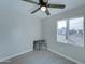 Bedroom with large window, ceiling fan, and bicycle art at 2191 S Descanso Rd, Apache Junction, AZ 85119