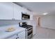 Updated kitchen with white cabinets, quartz countertops, and stainless steel appliances at 2191 S Descanso Rd, Apache Junction, AZ 85119