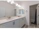 Double vanity bathroom with modern finishes and a shower/tub combo at 22413 N 101St Ave, Peoria, AZ 85383