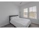 Cozy bedroom with a queen-size bed and ample natural light at 22413 N 101St Ave, Peoria, AZ 85383