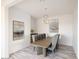 Elegant dining room featuring a large wooden table and modern lighting at 22413 N 101St Ave, Peoria, AZ 85383