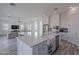 Modern kitchen with island, stainless steel appliances, and white cabinets at 22413 N 101St Ave, Peoria, AZ 85383