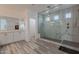 Large walk-in shower with marble tile and built-in seat at 22413 N 101St Ave, Peoria, AZ 85383