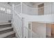 Modern white staircase with gray carpet runner at 22413 N 101St Ave, Peoria, AZ 85383