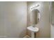 Clean bathroom with pedestal sink and oval mirror at 225 W 1St St # 118, Mesa, AZ 85201