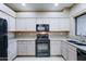 Modern kitchen with granite counters and black appliances at 225 W 1St St # 118, Mesa, AZ 85201