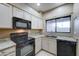 Modern kitchen with granite counters and black appliances at 225 W 1St St # 118, Mesa, AZ 85201