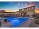 Luminous pool at dusk with string lights and a relaxing patio area at 2346 S Banning St, Gilbert, AZ 85295