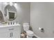 Bathroom with white vanity, toilet, and oval mirror at 2346 S Banning St, Gilbert, AZ 85295