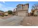 Two-story house with a beige exterior, two-car garage, and landscaping at 2346 S Banning St, Gilbert, AZ 85295