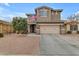 Two-story house with beige exterior, two-car garage, and American flag at 2346 S Banning St, Gilbert, AZ 85295