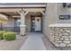 Front porch with stone pillars, white door, and landscaping at 2346 S Banning St, Gilbert, AZ 85295