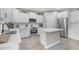 Modern kitchen with white cabinets, stainless steel appliances, and an island at 2346 S Banning St, Gilbert, AZ 85295